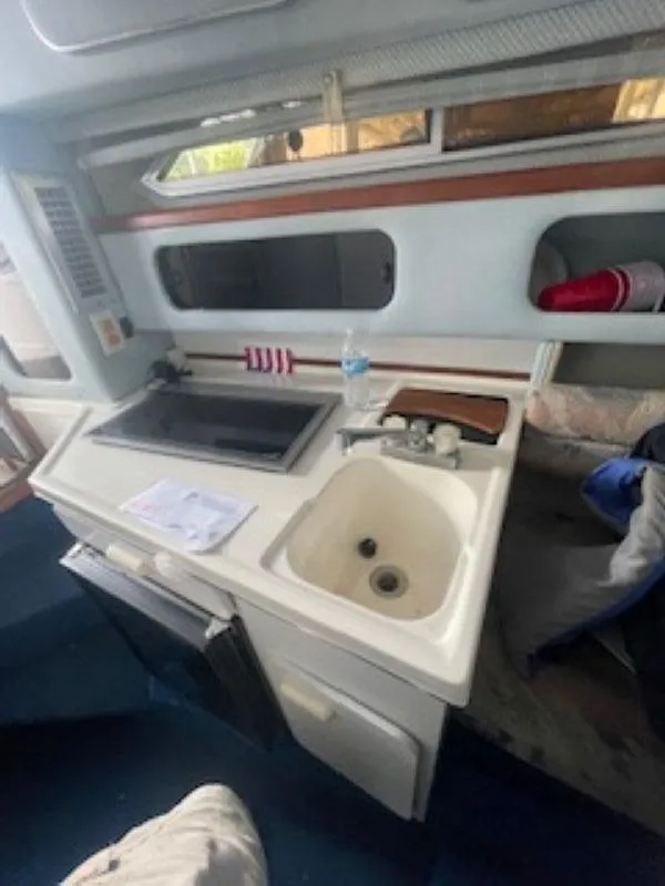 Slide: The Image of Interior of 1989 Sea Ray 250 DA boat with kitchenette and sink. - 10