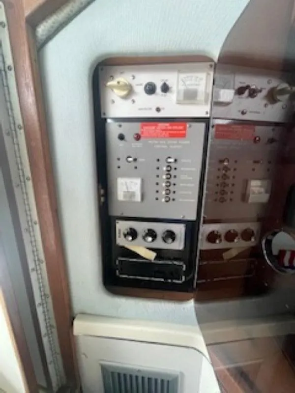 Slide: The Image of Control panel of a 1989 Sea Ray 250 DA boat, featuring various switches and gauges. - 12