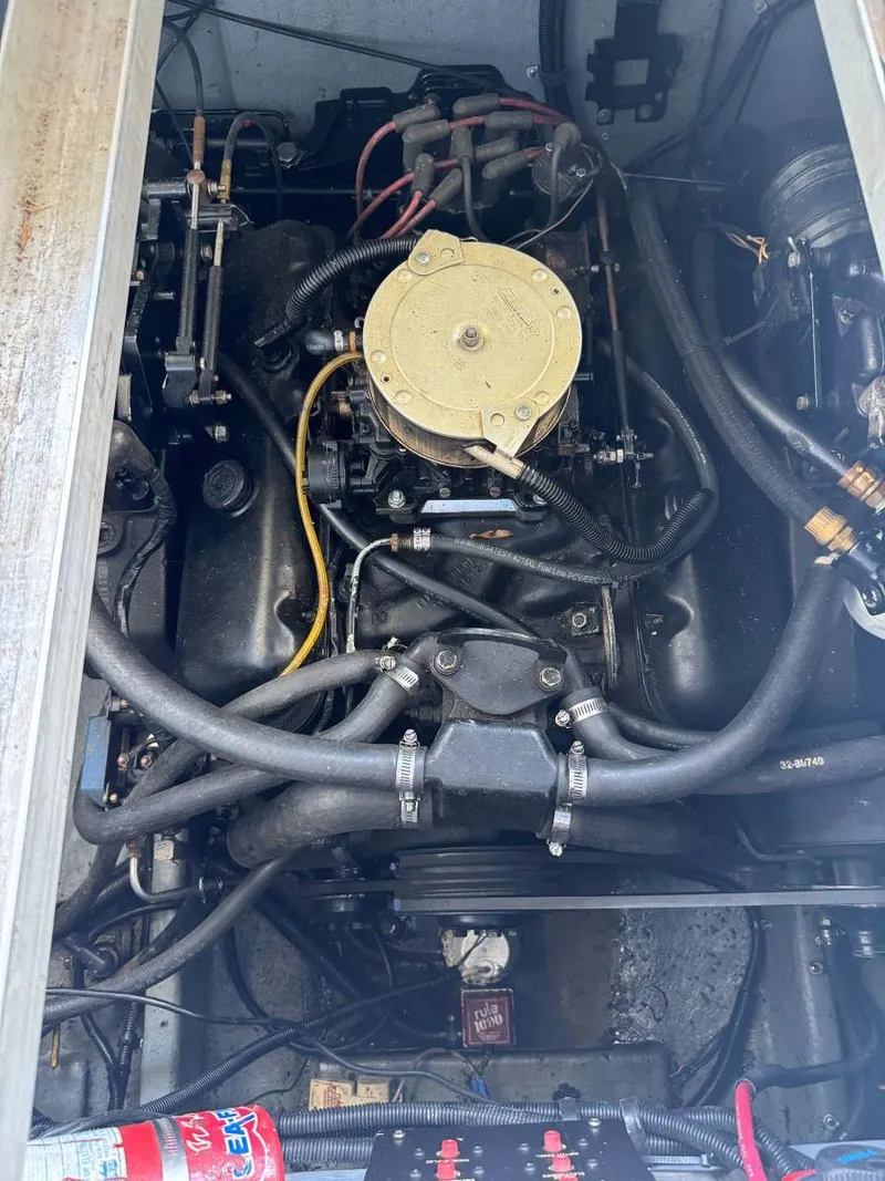 Slide: The Image of Engine compartment of a 1989 Sea Ray 250 DA boat, showcasing mechanical components and wiring. - 15