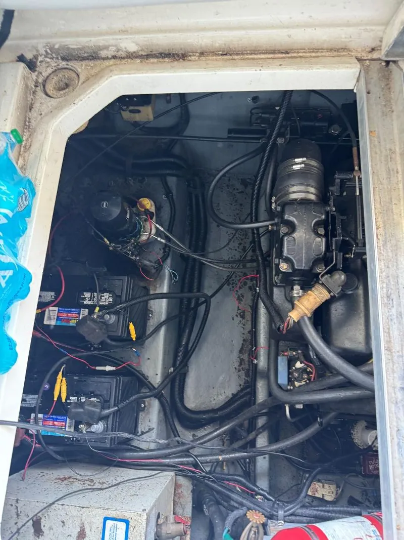Slide: The Image of Engine compartment of a 1989 Sea Ray 250 DA boat, showing wiring and components. - 16