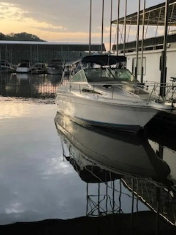 Slide: The Image of 1989 Sea Ray 250 DA boat docked at marina during sunset. - 3