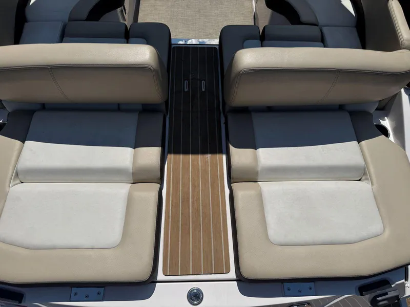 Slide: The Image of 2014 Regal 2300 Bowrider boat interior with beige seating and wooden flooring. - 11