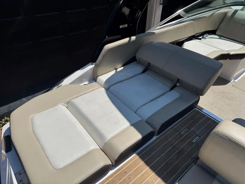 Slide: The Image of 2014 Regal 2300 Bowrider boat interior with beige and white seating. - 13