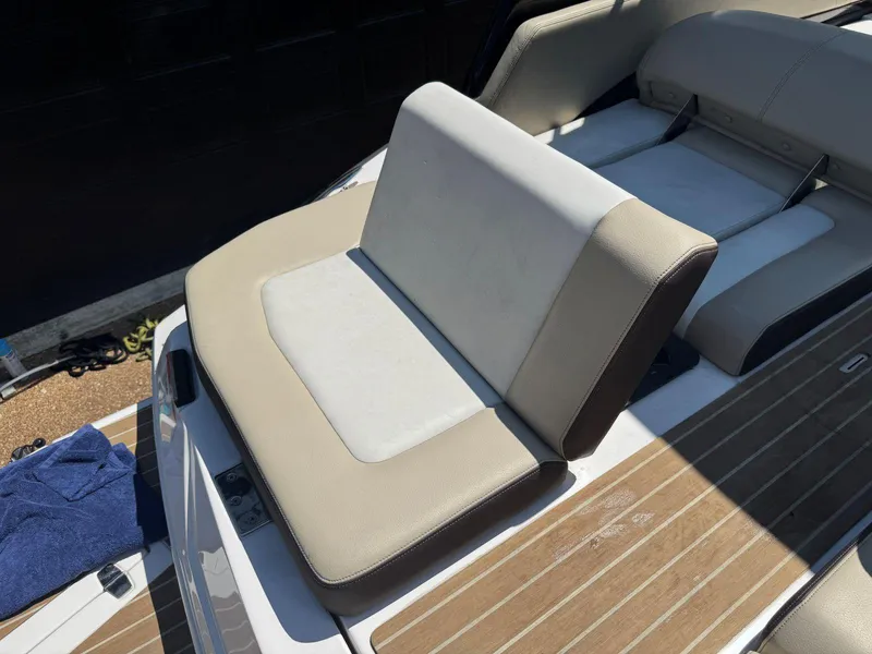 Slide: The Image of 2014 Regal 2300 Bowrider boat seating with beige and white upholstery. - 14