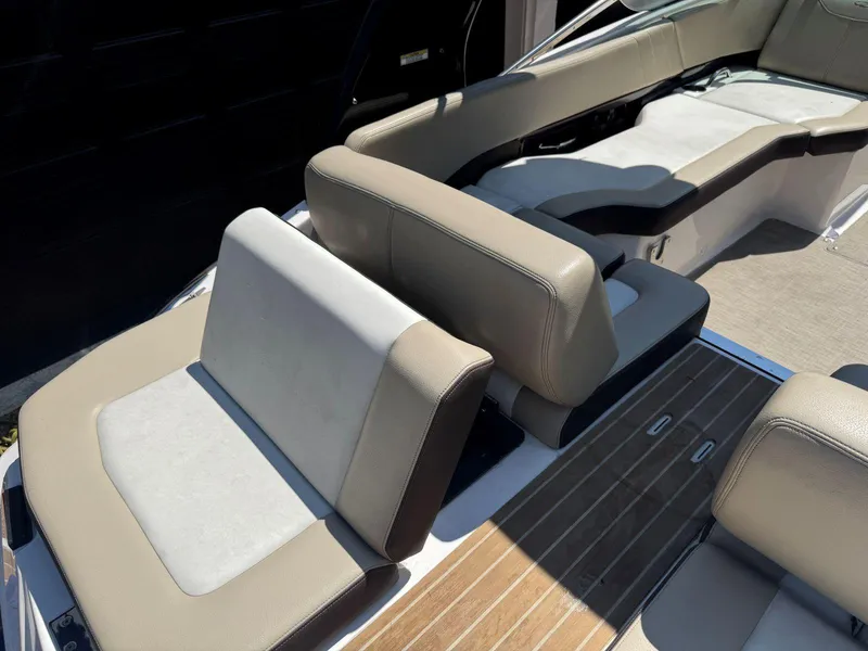 Slide: The Image of 2014 Regal 2300 Bowrider interior with beige seating and wooden flooring. - 15