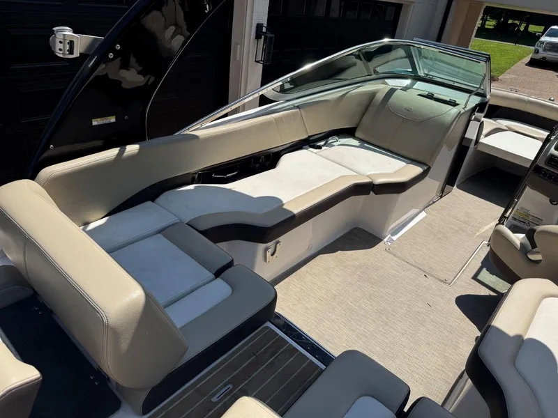 Slide: The Image of 2014 Regal 2300 Bowrider interior with beige seating and spacious layout. - 16