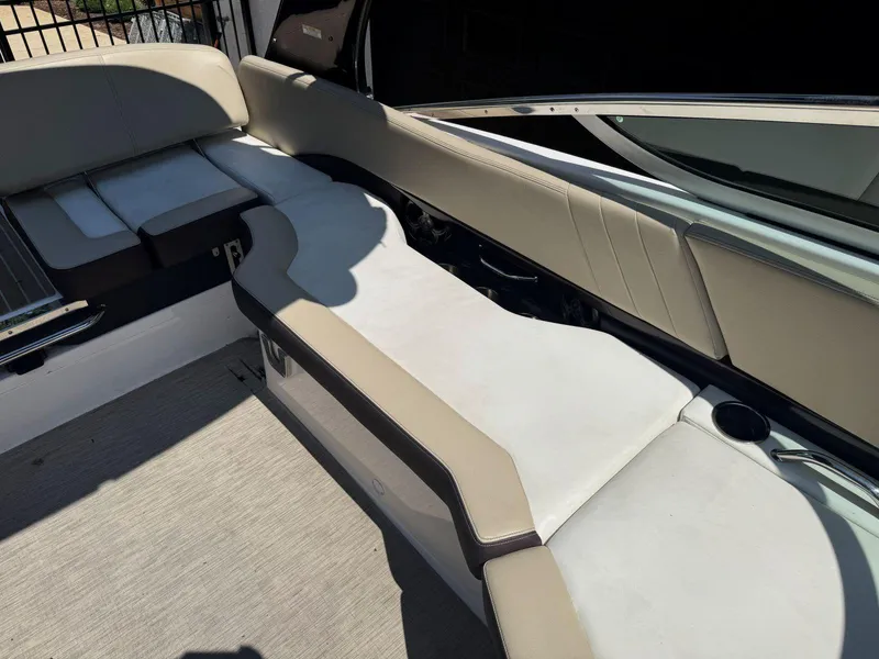 Slide: The Image of 2014 Regal 2300 Bowrider interior seating with beige upholstery and cup holder. - 18