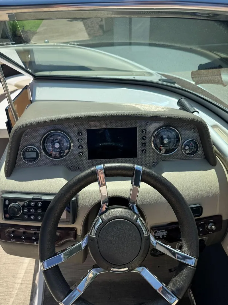 Slide: The Image of Dashboard of a 2014 Regal 2300 Bowrider boat with steering wheel and gauges. - 19