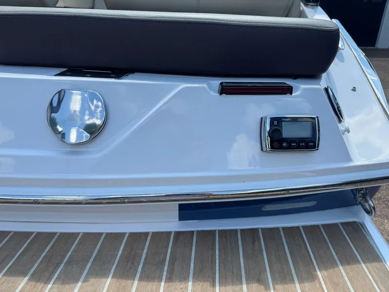 Slide: The Image of 2014 Regal 2300 Bowrider boat rear view with audio controls and seating. - 9
