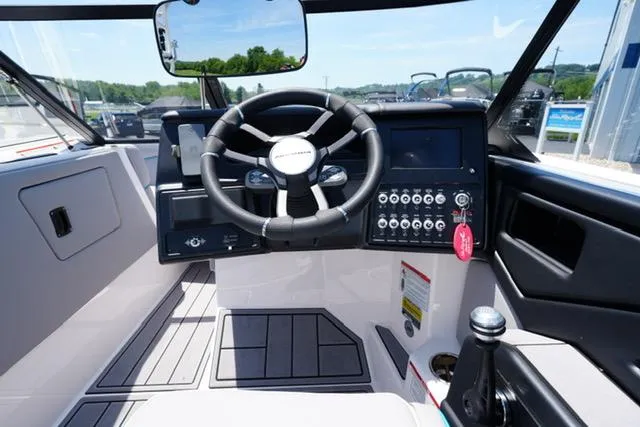 Slide: The Image of 2023 Moomba Kaiyen boat cockpit with steering wheel and control panel. - 10