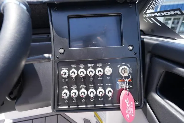 Slide: The Image of Control panel of 2023 Moomba Kaiyen boat with switches and screen. - 11