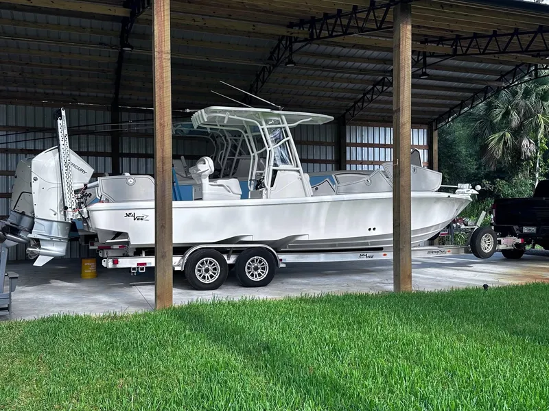 Slide: The Image of 2023 SeaVee 270Z boat on trailer under shelter, side view. - 10