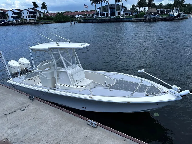 Slide: The Image of 2023 SeaVee 270Z boat docked by waterfront homes, featuring dual Mercury engines. - 11