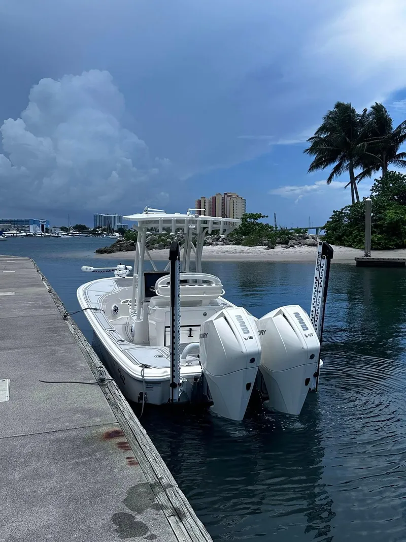 Slide: The Image of 2023 SeaVee 270Z boat docked by a tropical shoreline with palm trees. - 13