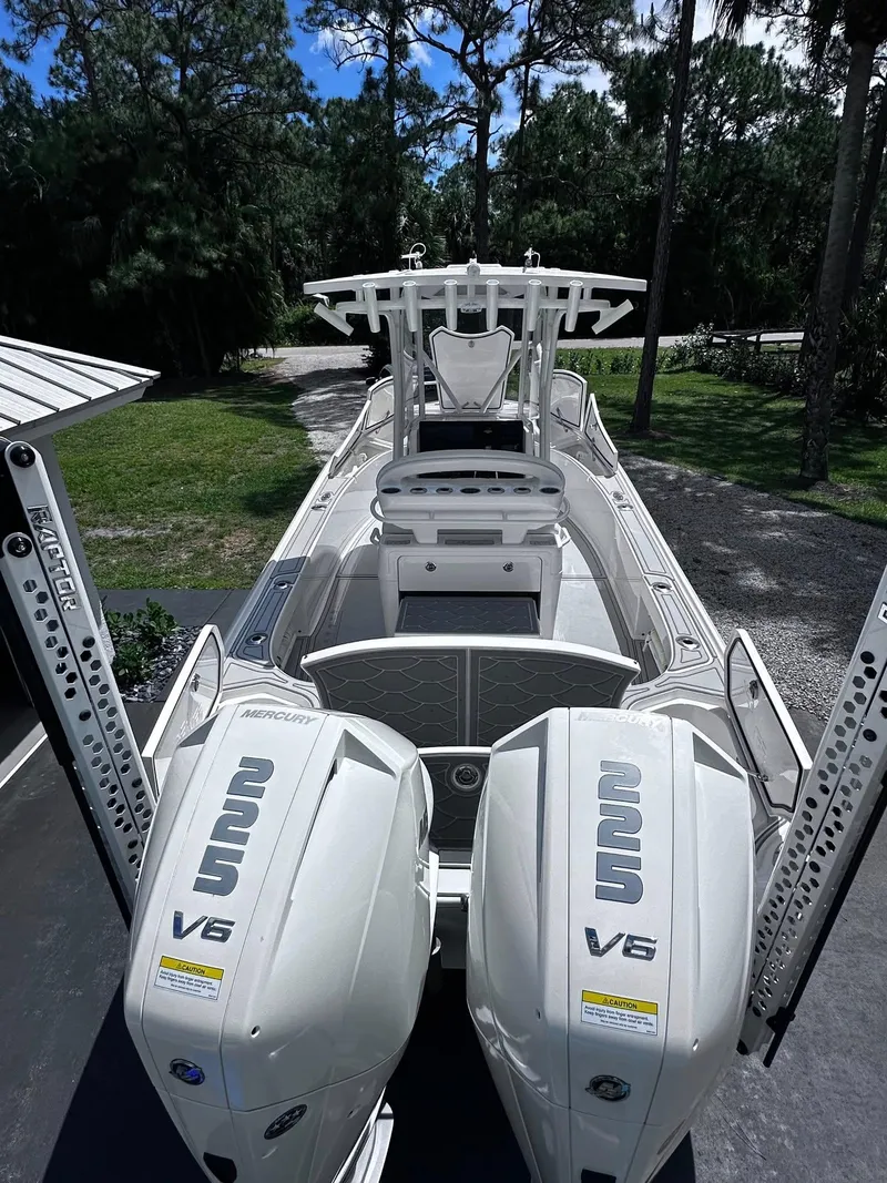 Slide: The Image of 2023 SeaVee 270Z boat with dual Mercury V6 engines, parked outdoors. - 16