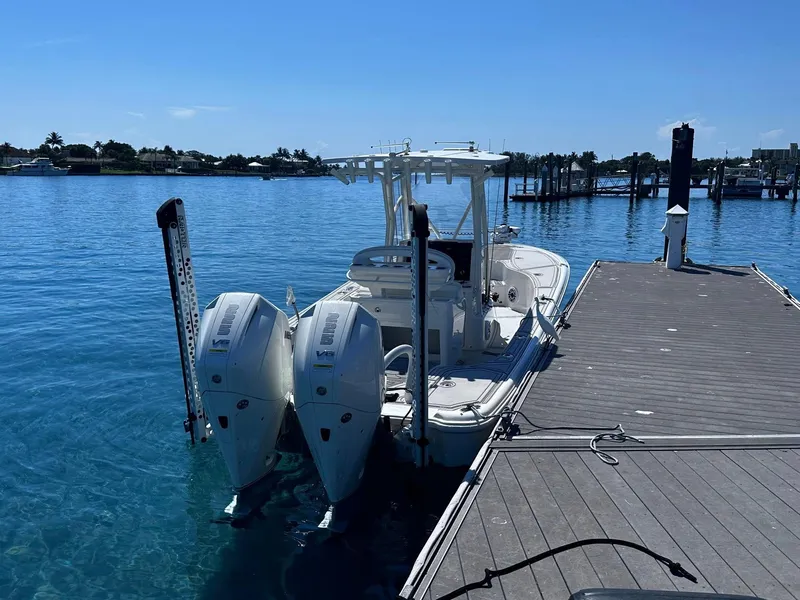 Slide: The Image of 2023 SeaVee 270Z boat docked with dual outboard engines on a sunny day. - 20