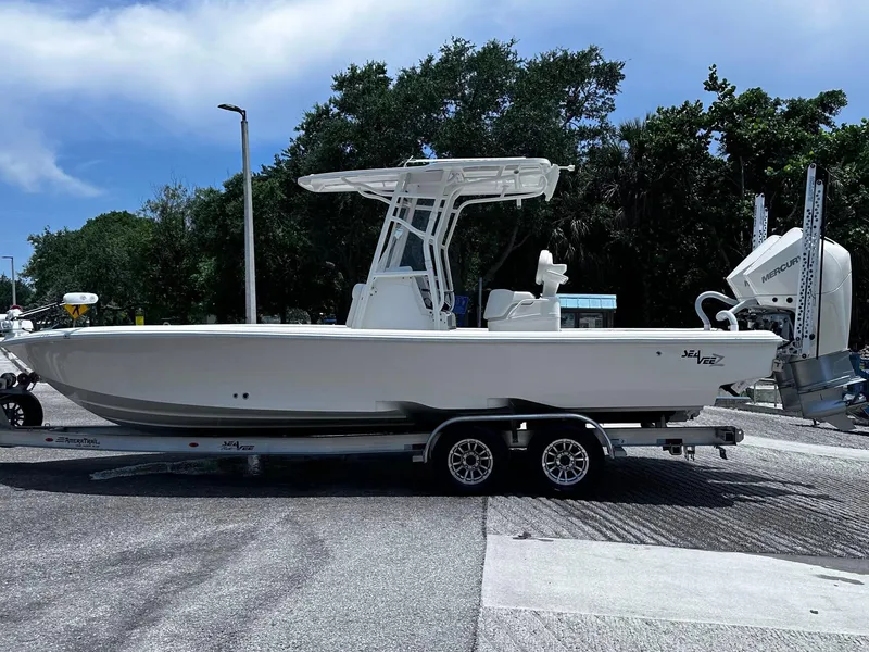 Slide: The Image of 2023 SeaVee 270Z boat on trailer, parked outdoors, side view. - 27