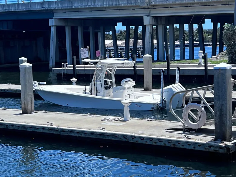 Slide: The Image of 2023 SeaVee 270Z boat docked at a marina under a bridge. - 3