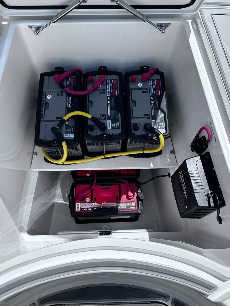 Slide: The Image of 2023 SeaVee 270Z boat battery compartment with multiple batteries and wiring. - 6