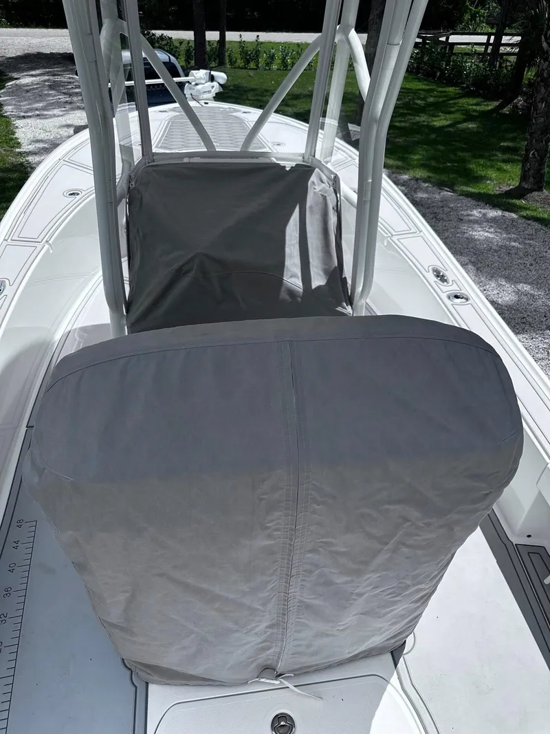 Slide: The Image of 2023 SeaVee 270Z boat with covered seating and console, viewed from the deck. - 7