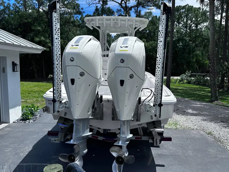 Slide: The Image of 2023 SeaVee 270Z boat with dual outboard engines, parked outdoors. - 8