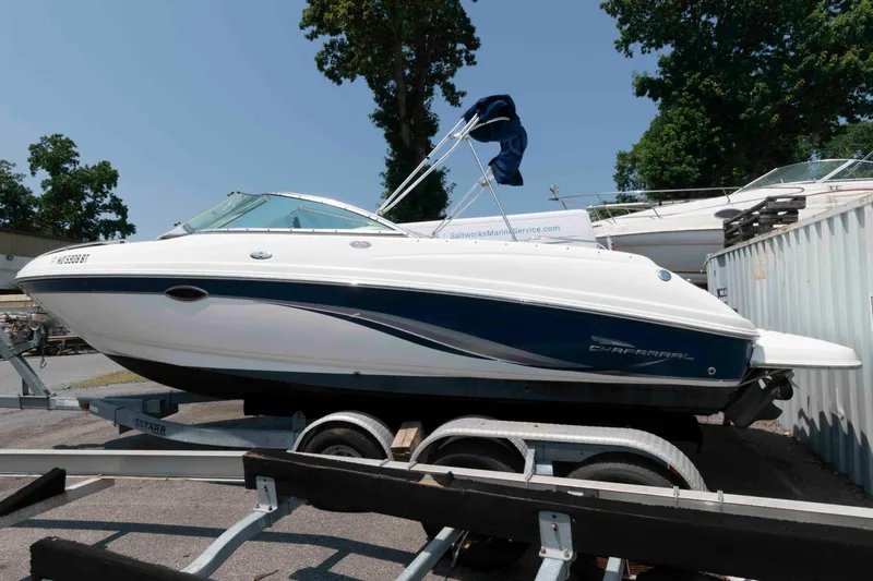 Slide: The Image of 2004 Chaparral 230 SSi boat on trailer, parked outdoors, side view. - 2