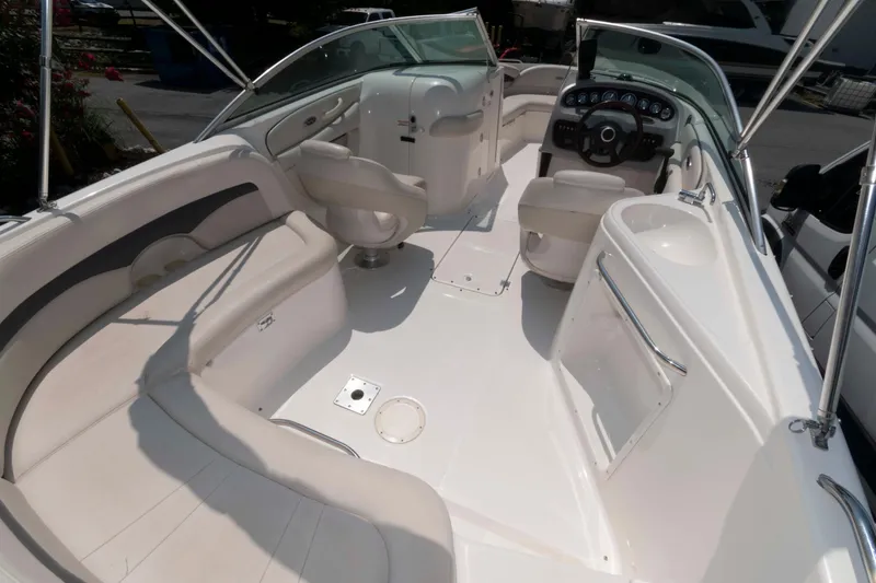 Slide: The Image of 2004 Chaparral 230 SSi boat interior with seating, steering wheel, and sink. - 4