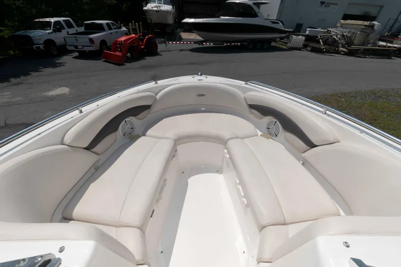 Slide: The Image of 2004 Chaparral 230 SSi boat interior with white seating and speakers. - 5