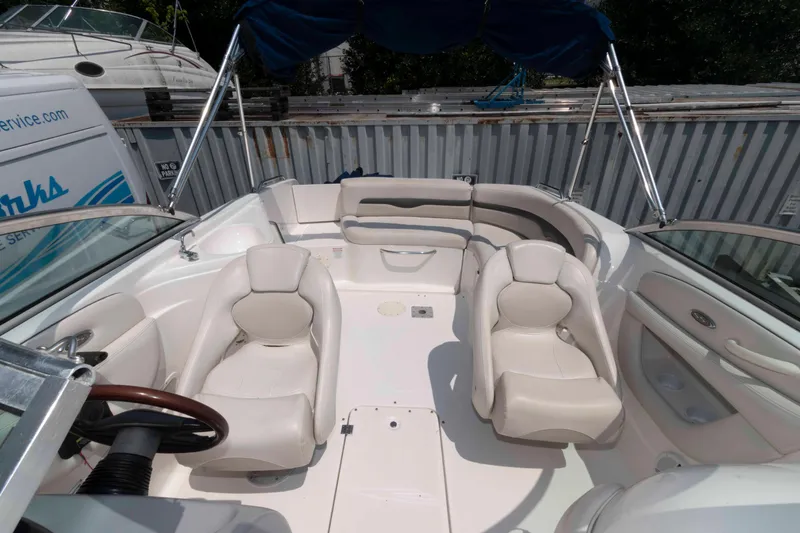 Slide: The Image of 2004 Chaparral 230 SSi boat interior with white seating and steering wheel. - 6