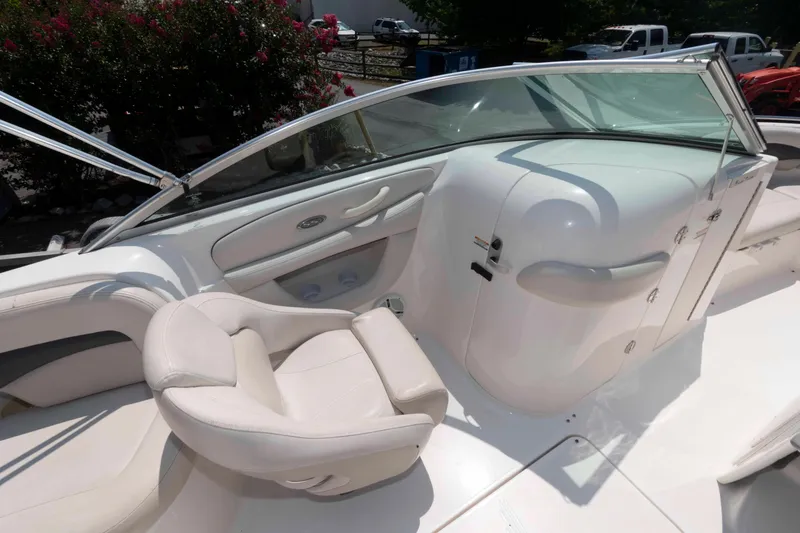 Slide: The Image of 2004 Chaparral 230 SSi boat interior with white seating and windshield. - 9