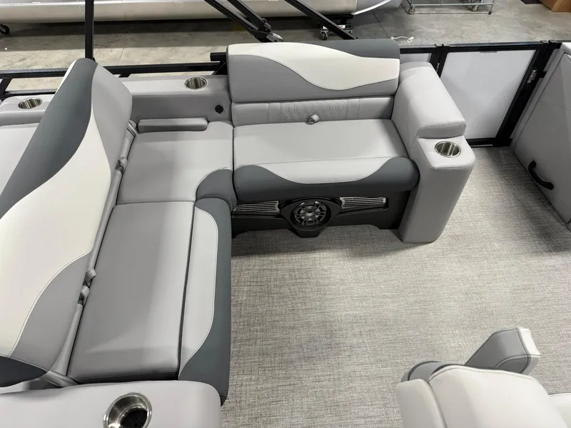 Slide: The Image of 2025 Avalon LSZ Versatile Rear Lounger interior with gray and white seating, cup holders, and speaker. - 12
