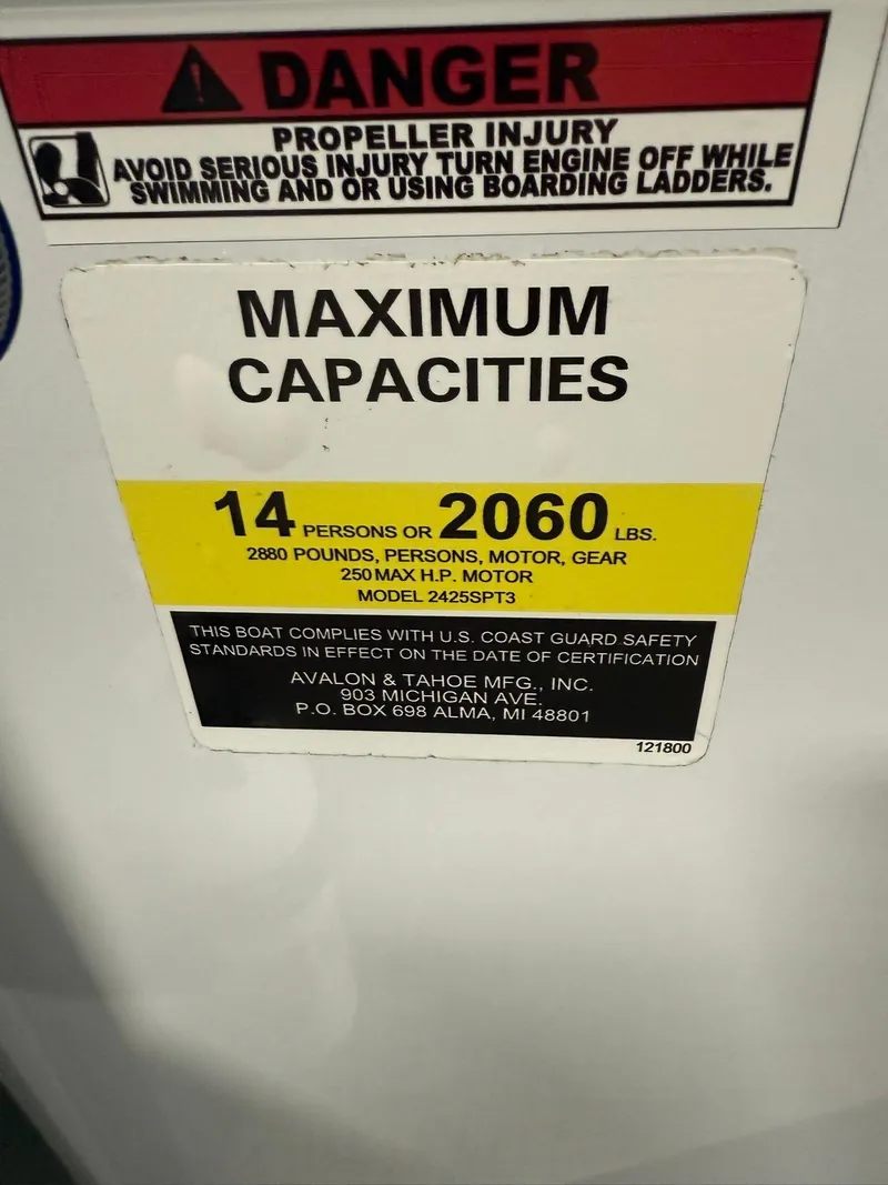 Slide: The Image of 2025 Avalon LSZ Versatile Rear Lounger capacity warning label, 14 persons or 2060 lbs, safety notice. - 14