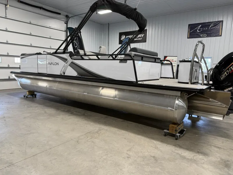 Slide: The Image of 2025 Avalon LSZ Versatile Rear Lounger pontoon boat in showroom, side view. - 3