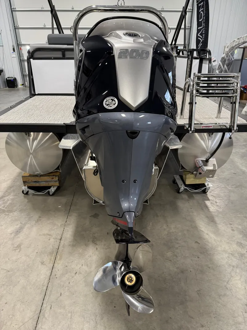 Slide: The Image of 2025 Avalon LSZ Versatile Rear Lounger with powerful outboard motor in a showroom. - 5