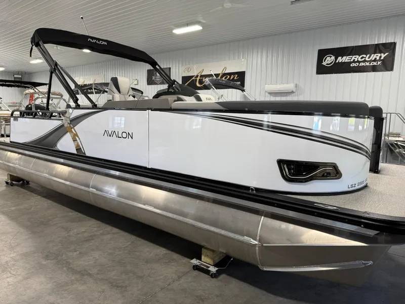 Slide: The Image of 2025 Avalon LSZ Versatile Rear Lounger pontoon boat in showroom, featuring sleek design and modern amenities. - 7