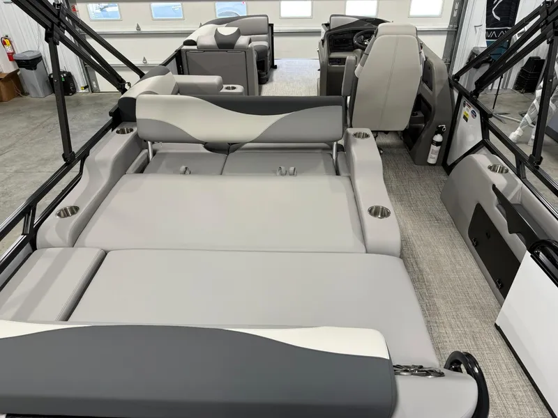 Slide: The Image of 2025 Avalon LSZ Versatile Rear Lounger interior with gray seating and cup holders. - 9