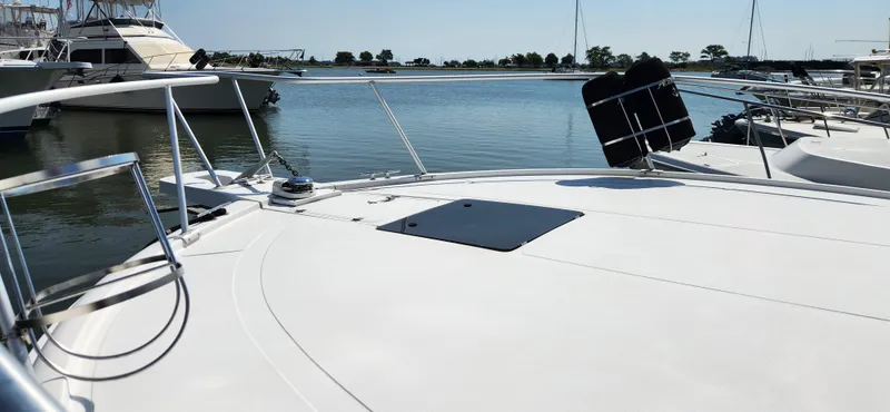 Slide: The Image of 1996 Luhrs 32 Convertible yacht docked in a serene marina setting. - 11