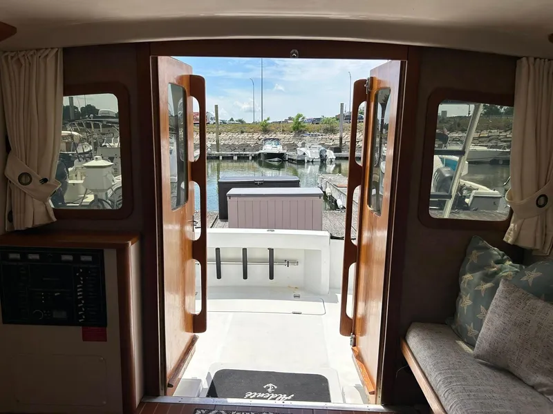Slide: The Image of Interior view of 1996 Luhrs 32 Convertible yacht, showcasing open doors to marina. - 15