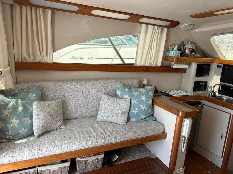 Slide: The Image of Interior of a 1996 Luhrs 32 Convertible boat with cozy seating and nautical decor. - 16
