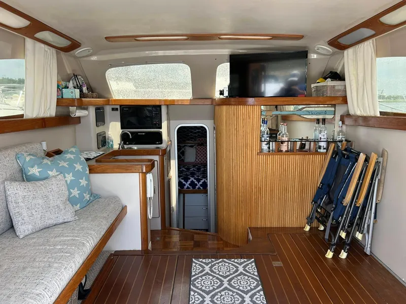 Slide: The Image of Interior of 1996 Luhrs 32 Convertible boat with cozy seating and kitchenette. - 17