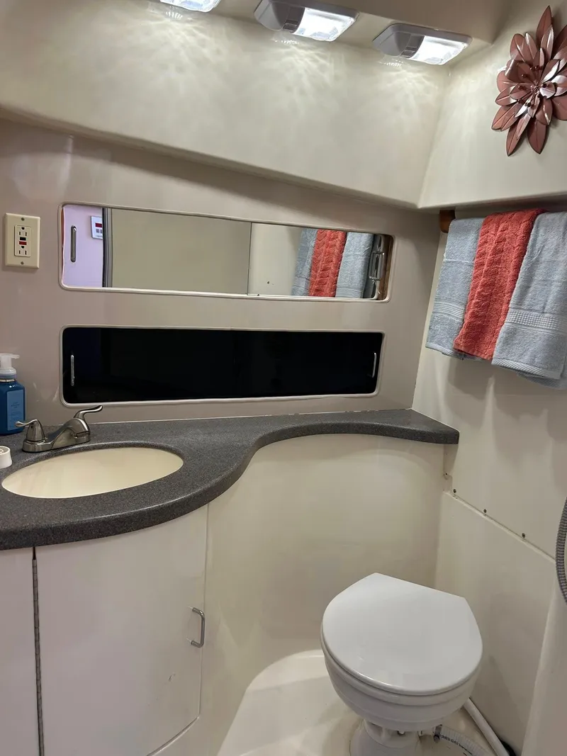 Slide: The Image of Bathroom interior of 1996 Luhrs 32 Convertible boat with sink, toilet, and mirror. - 22