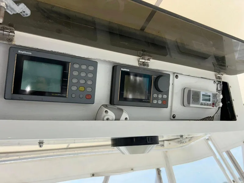 Slide: The Image of 1996 Luhrs 32 Convertible boat dashboard with Raytheon navigation equipment. - 23