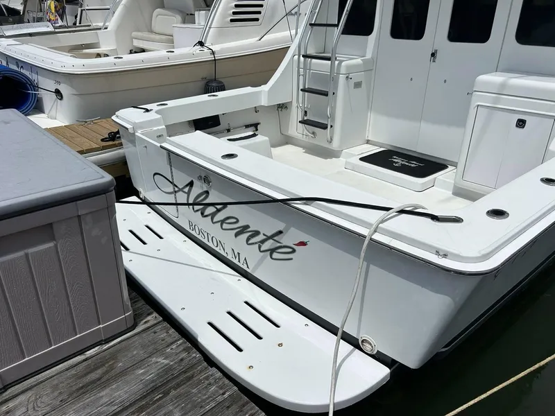 Slide: The Image of 1996 Luhrs 32 Convertible boat docked, named "Adente," located in Boston, MA. - 6