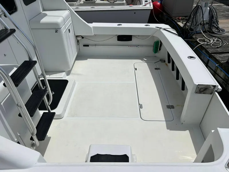 Slide: The Image of 1996 Luhrs 32 Convertible boat deck with ladder and storage compartments. - 7