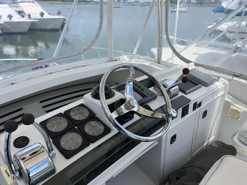 Slide: The Image of 1996 Luhrs 32 Convertible boat helm with steering wheel and control panel. - 9