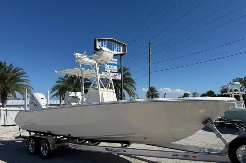 The Image of 2025 Pathfinder 2700 Open boat on trailer, parked outdoors under clear blue sky. - 0