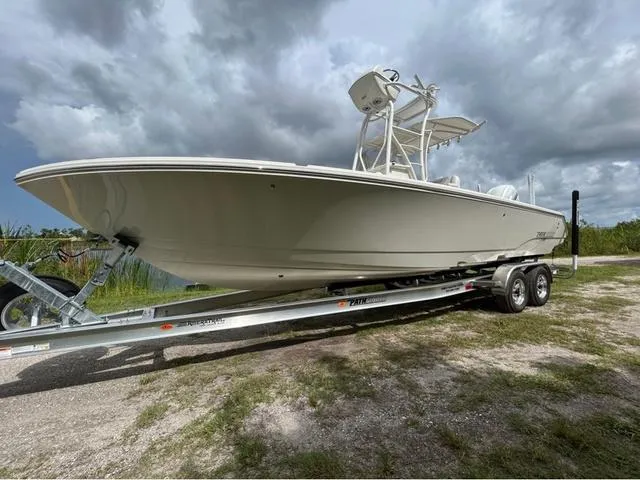 Slide: The Image of 2025 Pathfinder 2700 Open boat on trailer, displayed outdoors under clear blue sky. - 1