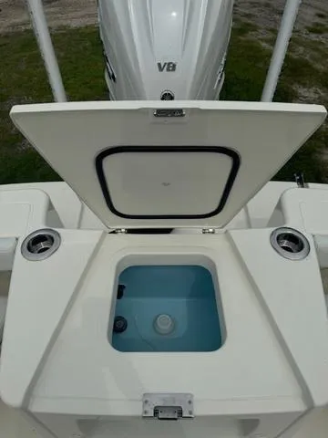 Slide: The Image of 2025 Pathfinder 2700 Open boat displayed outdoors with palm trees and clear blue sky. - 11