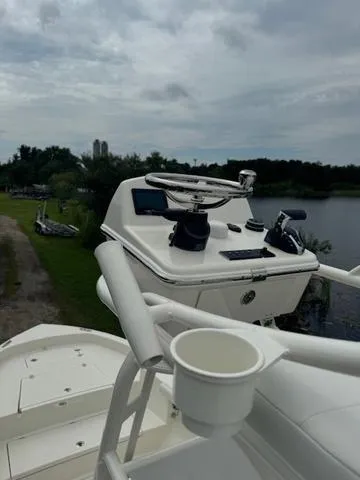 Slide: The Image of 2025 Pathfinder 2700 Open boat displayed at a dealership under clear blue skies. - 13