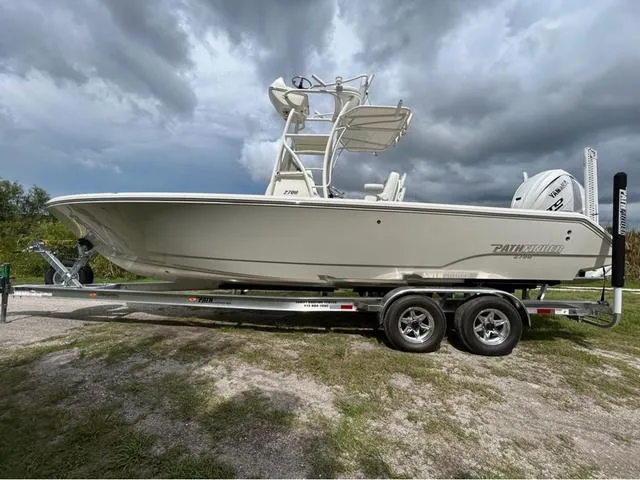 Slide: The Image of 2025 Pathfinder 2700 Open boat on trailer under clear blue sky. - 2